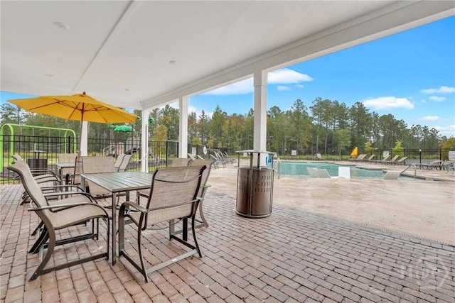 407 Coconut Dr, Bloomingdale, GA 31322 - view of patio with a community pool and view of scattered trees