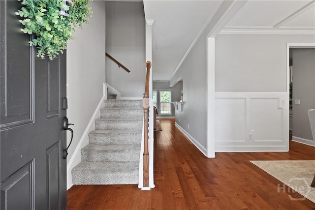 115 Meadowlands Dr, Rincon, GA 31326 - entrance foyer featuring wood finished floors, ornamental molding, stairway, a wainscoted wall, and baseboards