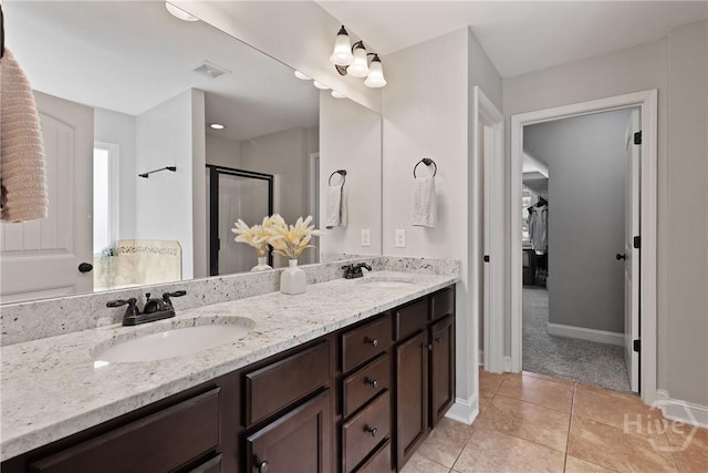 115 Meadowlands Dr, Rincon, GA 31326 - bathroom with double vanity, baseboards, tile patterned flooring, and a shower with door