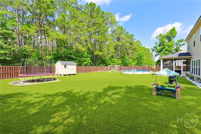 115 Meadowlands Dr, Rincon, GA 31326 - view of yard with a trampoline and a sunroom