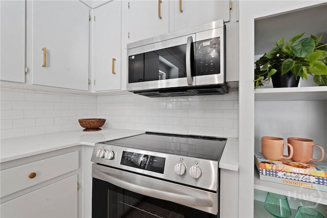 1939 Colonial Dr, Savannah, GA 31406 - kitchen featuring appliances with stainless steel finishes, backsplash, white cabinets, and light countertops