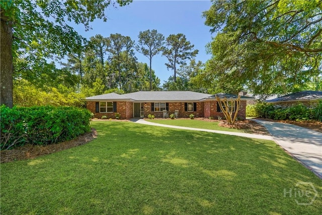 1939 Colonial Dr, Savannah, GA 31406 - ranch-style home featuring concrete driveway, a front lawn, and brick siding