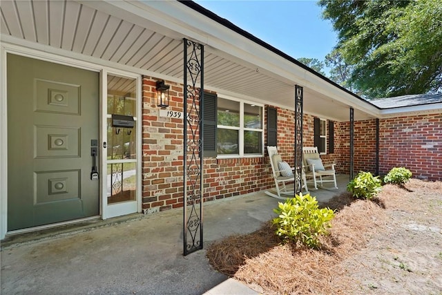 1939 Colonial Dr, Savannah, GA 31406 - view of exterior entry featuring covered porch and brick siding