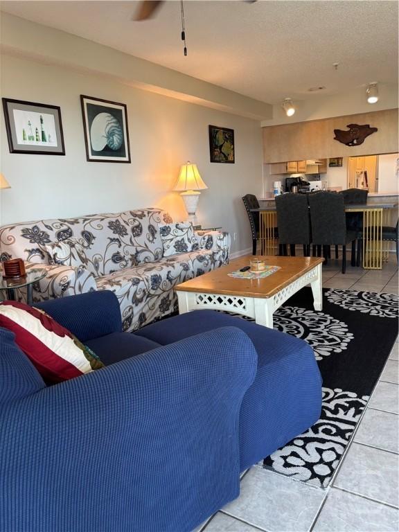 1 Center St Unit 3, Tybee Island, GA 31328 - living area featuring light tile patterned floors, a ceiling fan, and a textured ceiling