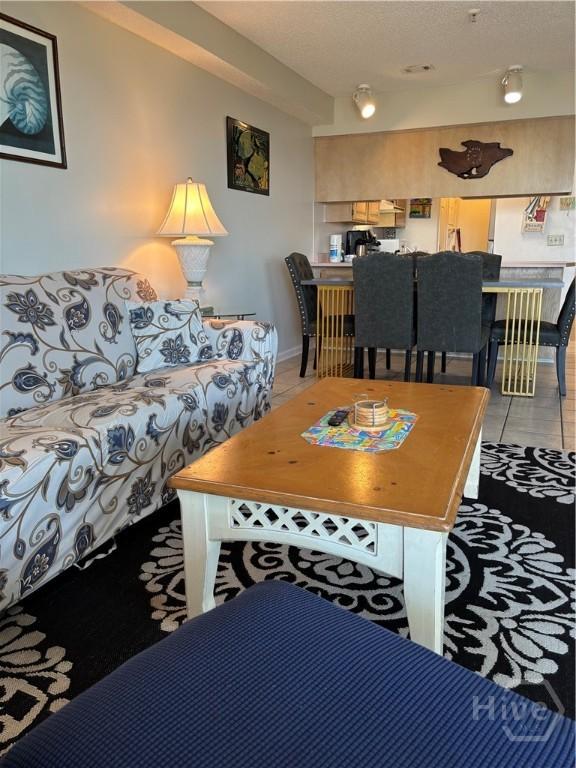 1 Center St Unit 3, Tybee Island, GA 31328 - living area featuring light tile patterned flooring and a textured ceiling