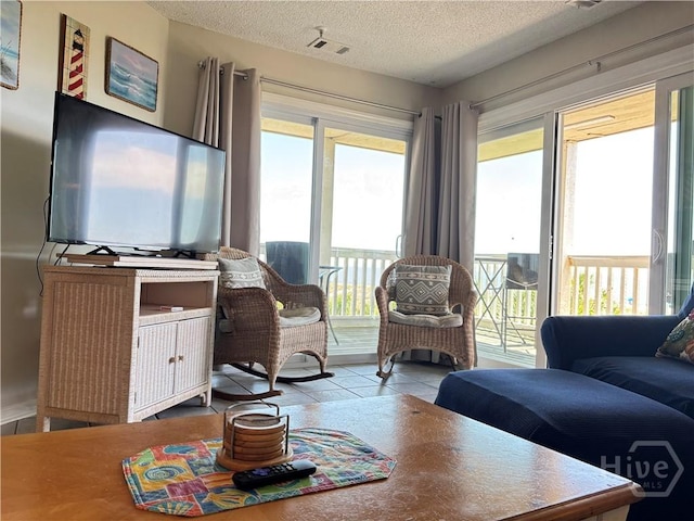 1 Center St Unit 3, Tybee Island, GA 31328 - tiled living room with a textured ceiling and plenty of natural light
