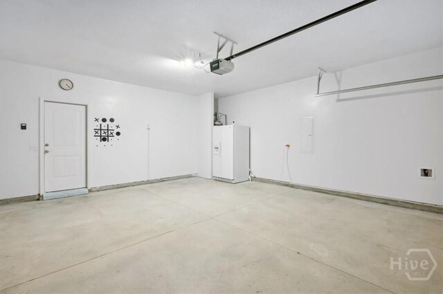 301 Akins Ranch Rd NE, Ludowici, GA 31316 - garage featuring white refrigerator with ice dispenser, a garage door opener, and electric panel