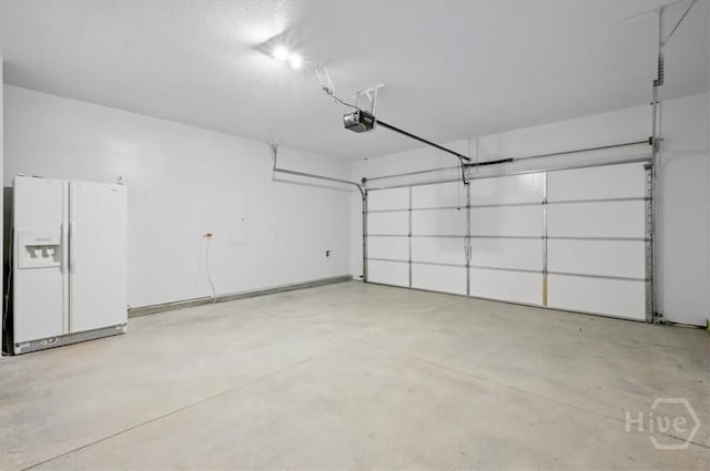 301 Akins Ranch Rd NE, Ludowici, GA 31316 - garage with white refrigerator with ice dispenser and a garage door opener