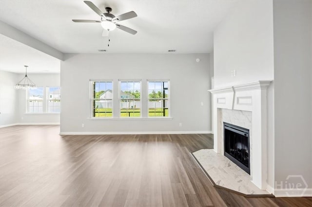 301 Akins Ranch Rd NE, Ludowici, GA 31316 - unfurnished living room with a premium fireplace, ceiling fan, dark wood finished floors, and baseboards