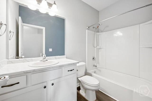 301 Akins Ranch Rd NE, Ludowici, GA 31316 - bathroom with vanity, toilet, washtub / shower combination, and wood finished floors