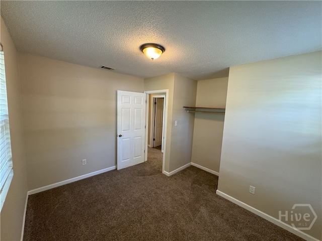 115 New Stillwell Rd, Springfield, GA 31329 - unfurnished bedroom with carpet, baseboards, a textured ceiling, and a closet