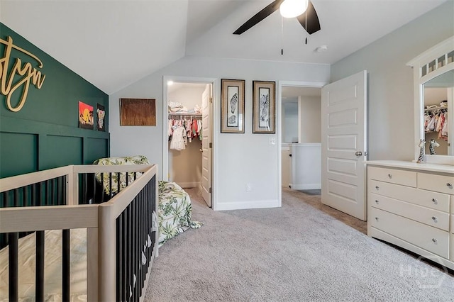 202 Thatcher St, Guyton, GA 31312 - carpeted bedroom featuring vaulted ceiling, a walk in closet, a ceiling fan, and baseboards