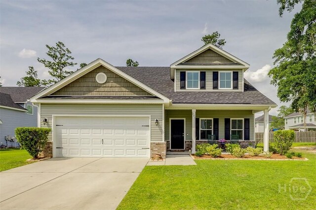 202 Thatcher St, Guyton, GA 31312 - craftsman house featuring a porch, concrete driveway, a front yard, and a garage