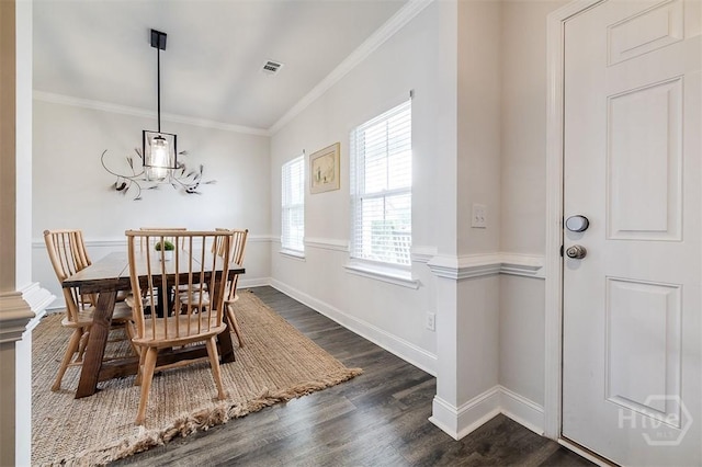 202 Thatcher St, Guyton, GA 31312 - dining area featuring dark wood finished floors, crown molding, and baseboards