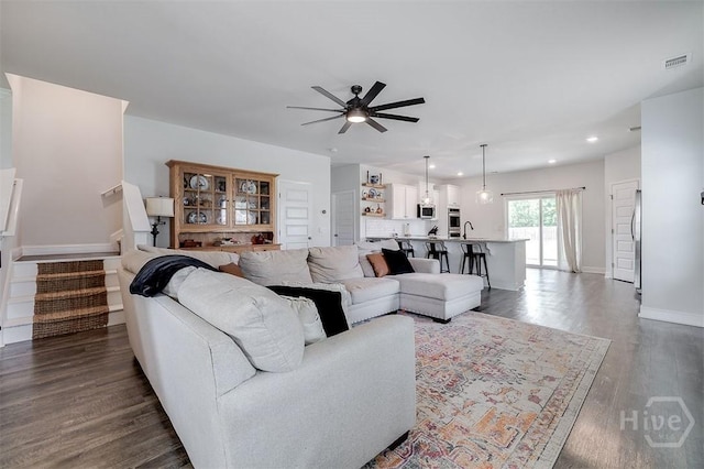 202 Thatcher St, Guyton, GA 31312 - living room with ceiling fan, recessed lighting, stairs, dark wood-style floors, and baseboards
