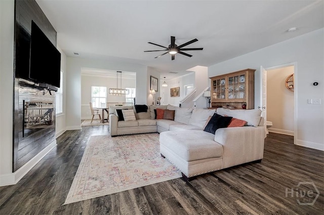 202 Thatcher St, Guyton, GA 31312 - living room featuring dark wood-type flooring, a ceiling fan, baseboards, and a chandelier