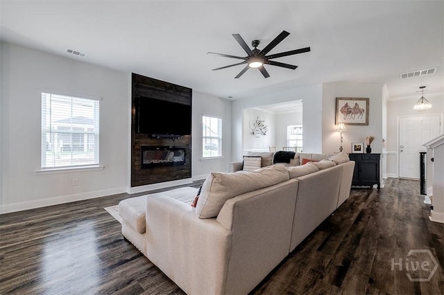 202 Thatcher St, Guyton, GA 31312 - living area with a ceiling fan, dark wood-style floors, baseboards, and a fireplace