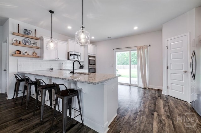 202 Thatcher St, Guyton, GA 31312 - kitchen featuring a sink, stainless steel appliances, white cabinets, a peninsula, and dark wood finished floors