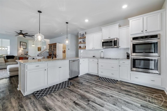 202 Thatcher St, Guyton, GA 31312 - kitchen with appliances with stainless steel finishes, a sink, a peninsula, white cabinets, and open shelves