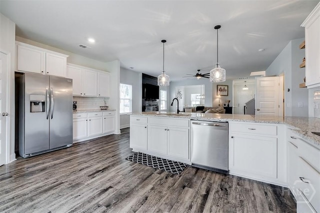 202 Thatcher St, Guyton, GA 31312 - kitchen featuring appliances with stainless steel finishes, a sink, open floor plan, dark wood finished floors, and ceiling fan