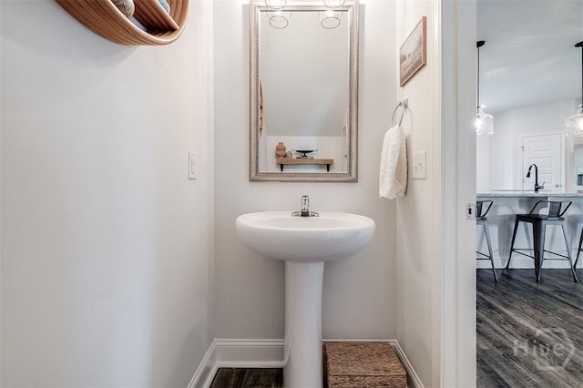 202 Thatcher St, Guyton, GA 31312 - bathroom with baseboards, wood finished floors, and a sink