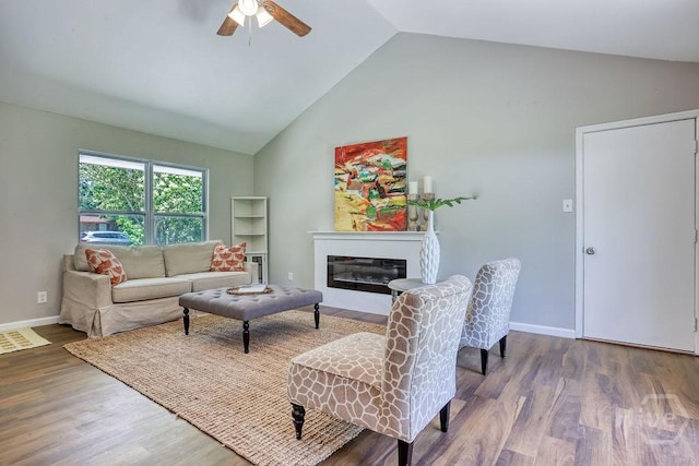 1522 Marcy Cir, Savannah, GA 31406 - living room featuring wood finished floors, a ceiling fan, a glass covered fireplace, high vaulted ceiling, and baseboards