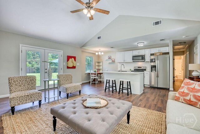 1522 Marcy Cir, Savannah, GA 31406 - living room with dark wood finished floors, high vaulted ceiling, french doors, baseboards, and a ceiling fan