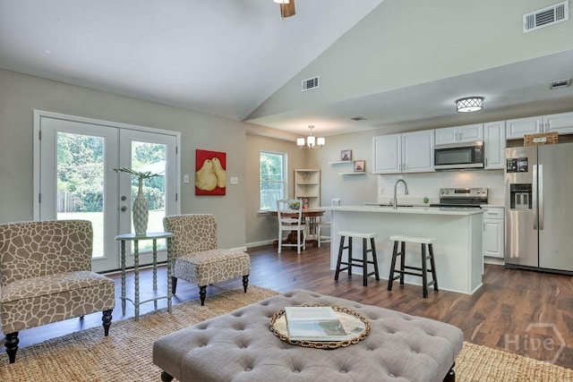 1522 Marcy Cir, Savannah, GA 31406 - living area with lofted ceiling, a chandelier, dark wood-type flooring, french doors, and baseboards