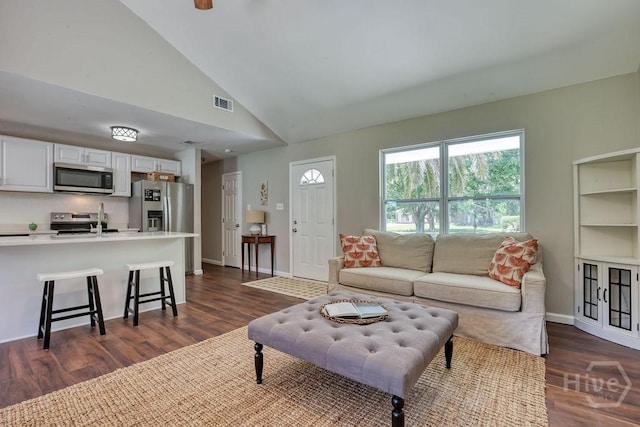 1522 Marcy Cir, Savannah, GA 31406 - living room with dark wood-style floors, vaulted ceiling, and baseboards