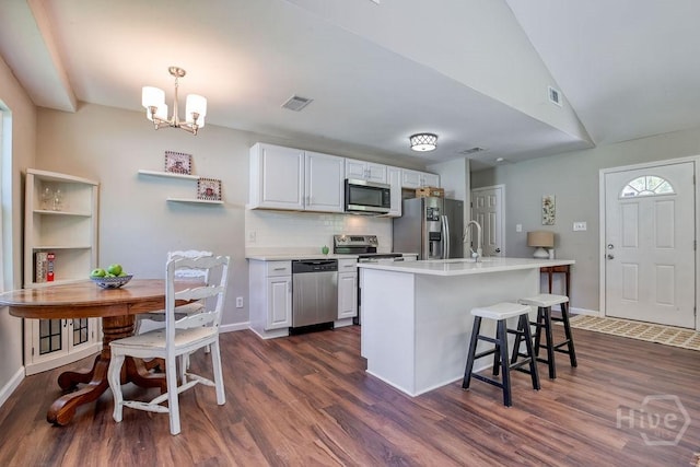 1522 Marcy Cir, Savannah, GA 31406 - kitchen with appliances with stainless steel finishes, dark wood-style floors, a chandelier, backsplash, and light countertops