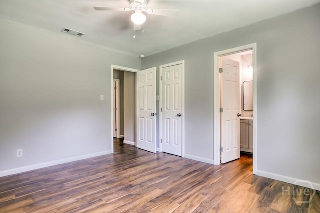 1522 Marcy Cir, Savannah, GA 31406 - unfurnished bedroom featuring wood finished floors, baseboards, connected bathroom, and ceiling fan
