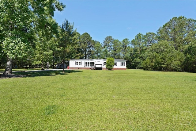 132 Waymaker Dr, Midway, GA 31320 - view of green lawn featuring a wooden deck