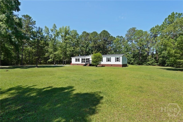 132 Waymaker Dr, Midway, GA 31320 - view of grassy yard with a deck