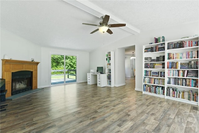 132 Waymaker Dr, Midway, GA 31320 - unfurnished living room with a textured ceiling, wood finished floors, a ceiling fan, a fireplace with raised hearth, and a desk