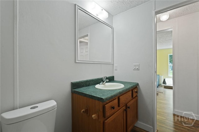 132 Waymaker Dr, Midway, GA 31320 - bathroom with a textured ceiling, vanity, toilet, and wood finished floors