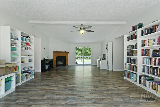 132 Waymaker Dr, Midway, GA 31320 - unfurnished living room featuring a textured ceiling, a fireplace with raised hearth, ceiling fan, wood finished floors, and baseboards