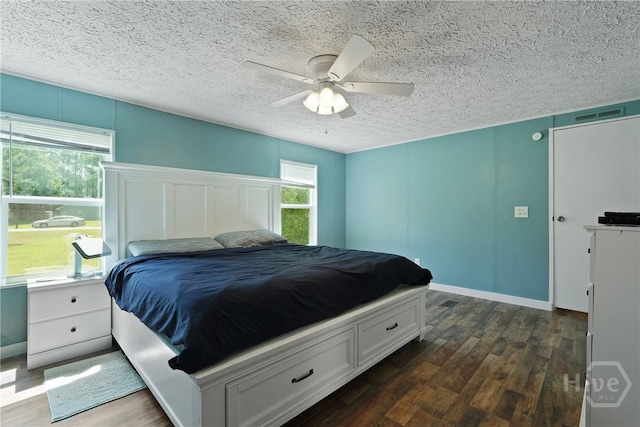 132 Waymaker Dr, Midway, GA 31320 - bedroom featuring dark wood-style flooring, a textured ceiling, and a ceiling fan