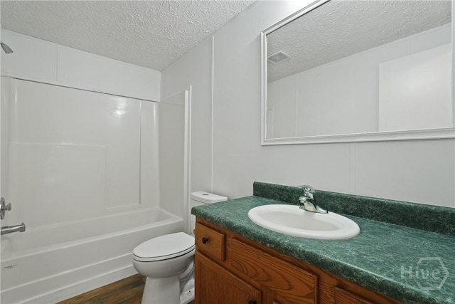 132 Waymaker Dr, Midway, GA 31320 - full bathroom featuring a textured ceiling, vanity, toilet, shower / bathtub combination, and wood finished floors