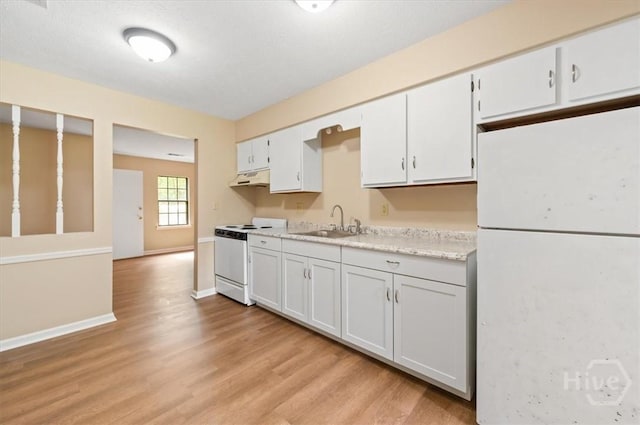 310 Ashmore St Unit A, B, Hinesville, GA 31313 - kitchen featuring white appliances, a sink, under cabinet range hood, light countertops, and light wood-style floors
