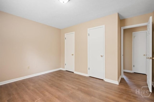 310 Ashmore St Unit A, B, Hinesville, GA 31313 - unfurnished bedroom featuring wood finished floors and baseboards