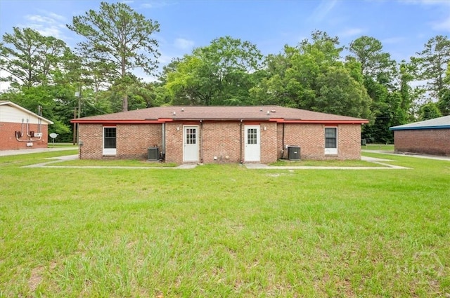 310 Ashmore St Unit A, B, Hinesville, GA 31313 - rear view of house with central air condition unit, a yard, and brick siding