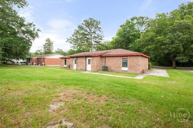 310 Ashmore St Unit A, B, Hinesville, GA 31313 - rear view of house with a lawn, central AC unit, and brick siding