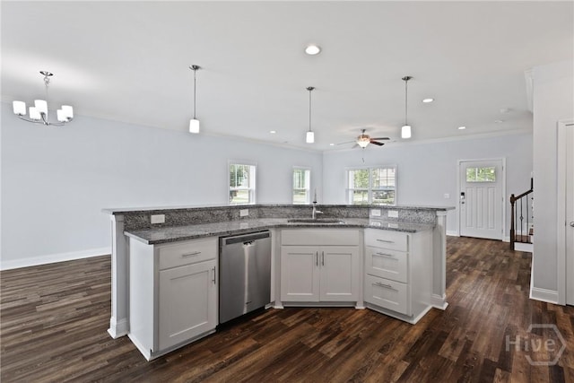 194 Shortleaf Trl, Richmond Hill, GA 31324 - kitchen with stainless steel dishwasher, a sink, dark wood-type flooring, a ceiling fan, and crown molding