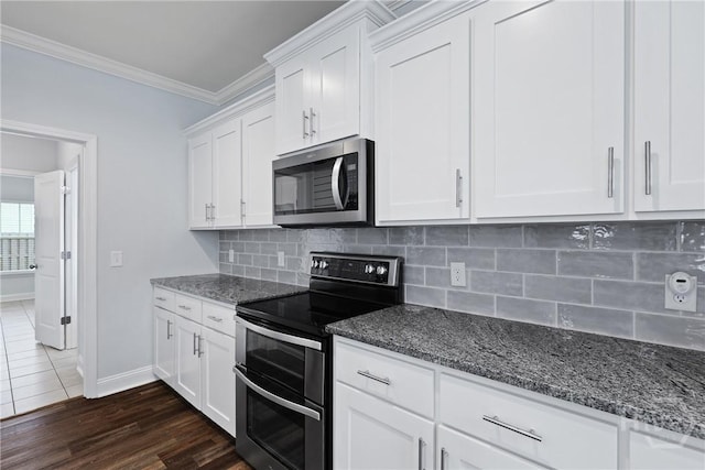 194 Shortleaf Trl, Richmond Hill, GA 31324 - kitchen with stainless steel appliances, dark stone counters, ornamental molding, and white cabinets
