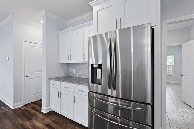 194 Shortleaf Trl, Richmond Hill, GA 31324 - kitchen with stainless steel fridge with ice dispenser, light stone countertops, backsplash, white cabinets, and ornamental molding