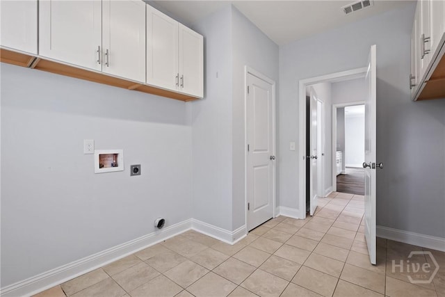194 Shortleaf Trl, Richmond Hill, GA 31324 - washroom featuring hookup for a washing machine, electric dryer hookup, cabinet space, light tile patterned flooring, and baseboards