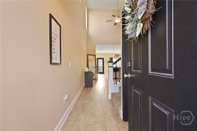 806 Fairview Cir, Hinesville, GA 31313 - foyer entrance featuring stairs, light wood-style flooring, a ceiling fan, baseboards, and a high ceiling