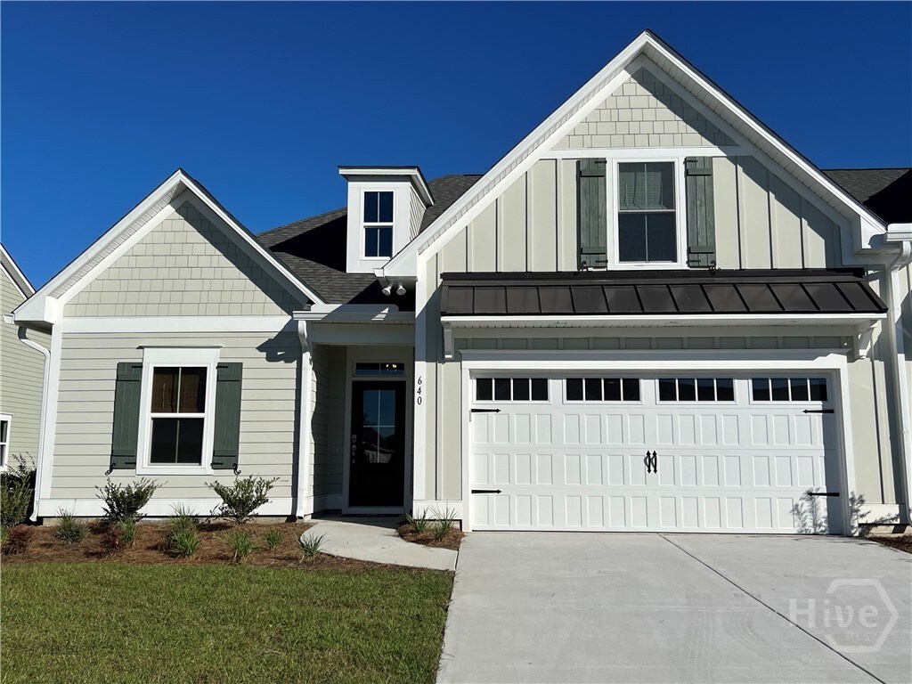 650 Blue Moon Xing, Pooler, GA 31322 - view of front of house featuring board and batten siding, driveway, a garage, and a shingled roof