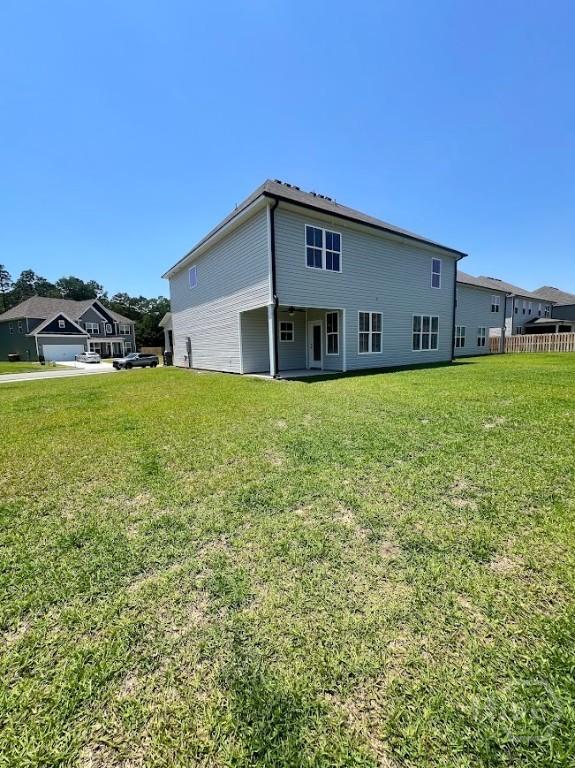 139 Sams Dr, Guyton, GA 31312 - rear view of property with a lawn