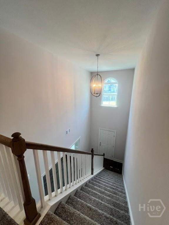 139 Sams Dr, Guyton, GA 31312 - staircase with carpet floors, a chandelier, and baseboards